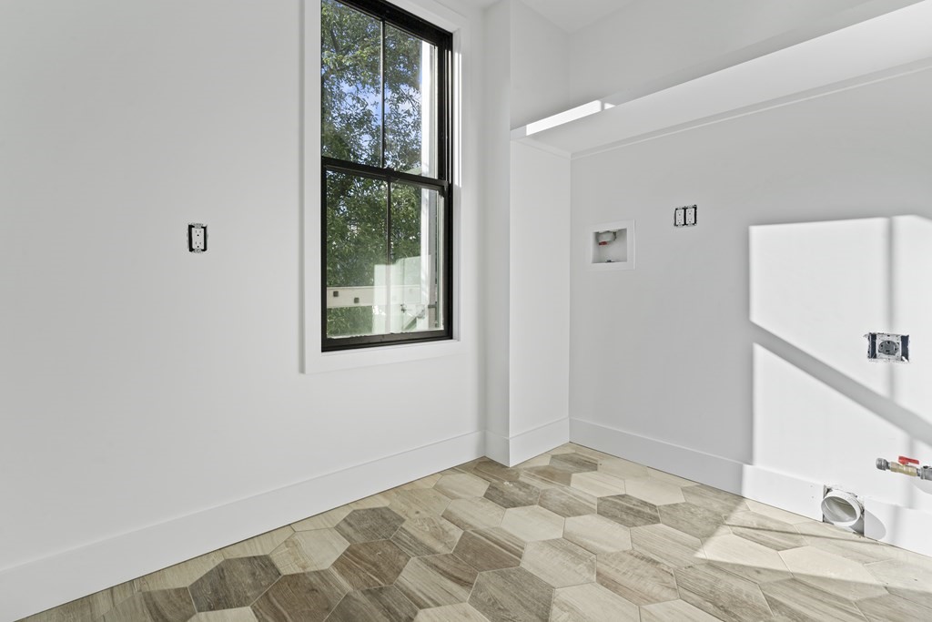 3 Pulaski Avenue Boston, MA 02127 - Photo 12 of 19 a view of a bedroom with wooden floor and a window