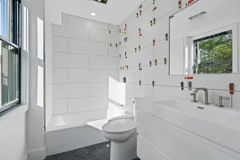 a bathroom with a sink toilet and shower