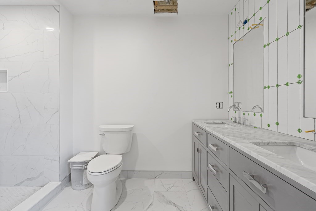 3 Pulaski Avenue Boston, MA 02127 - Photo 19 of 19 a bathroom with a granite countertop sink a toilet and a shower