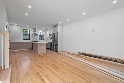 a view of kitchen with sink and refrigerator