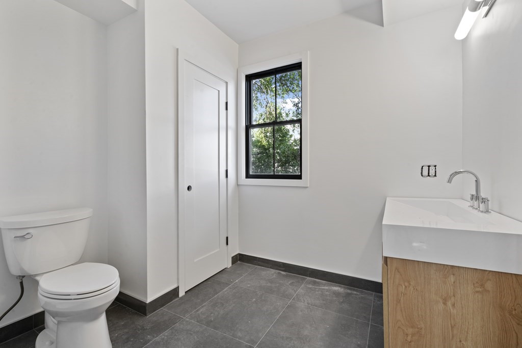3 Pulaski Avenue Boston, MA 02127 - Photo 9 of 19 a bathroom with a toilet sink and mirror