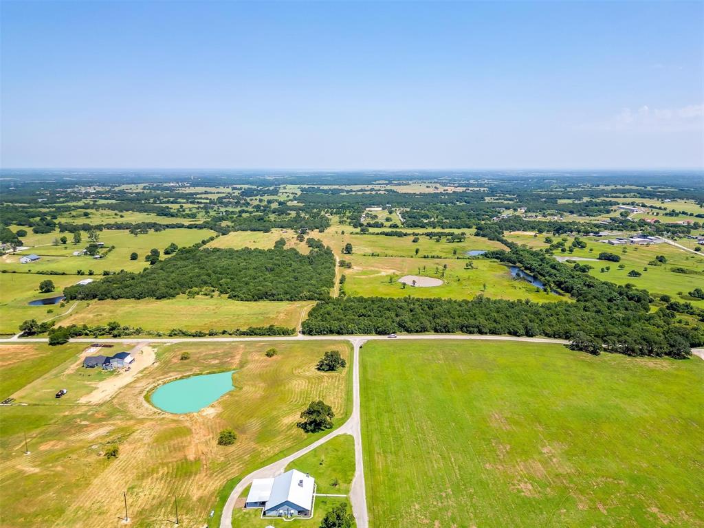 210 Trails End Poolville, TX 76487 - Photo 18 of 25 an aerial view of residential houses with outdoor space and swimming pool