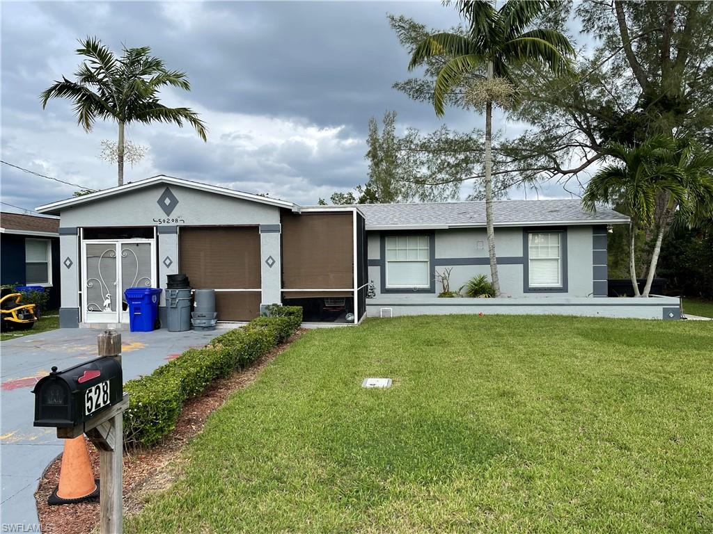a front view of a house with a garden and patio