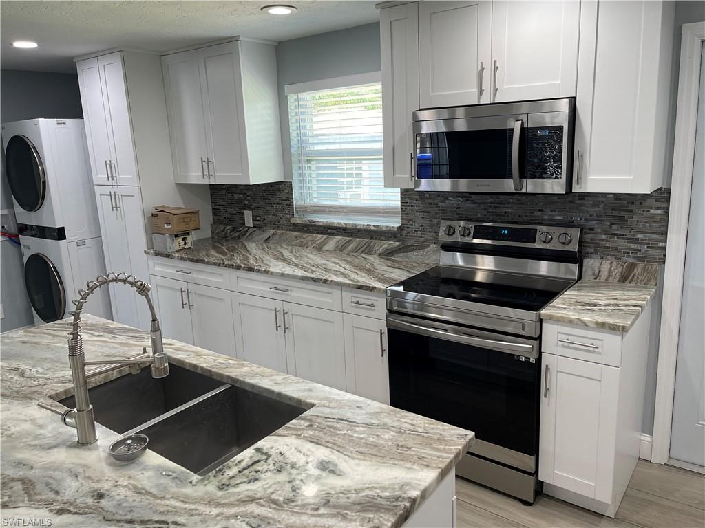 528 14th Street North Naples, FL 34102 - Photo 11 of 19 a kitchen with a stove and a microwave