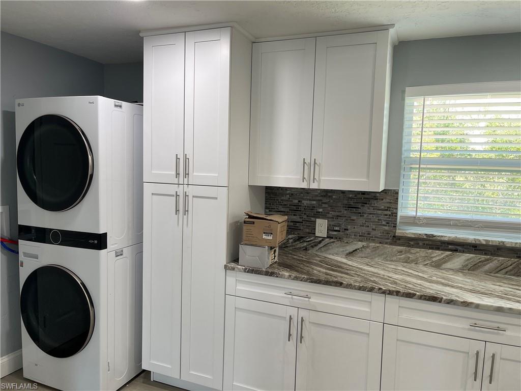 528 14th Street North Naples, FL 34102 - Photo 13 of 19 a kitchen with a washer and dryer