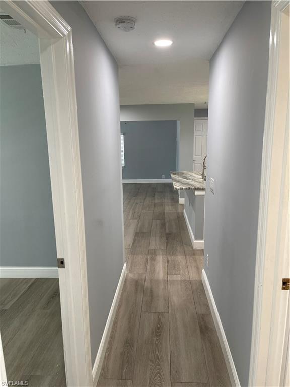528 14th Street North Naples, FL 34102 - Photo 15 of 19 a view of hallway with wooden floor