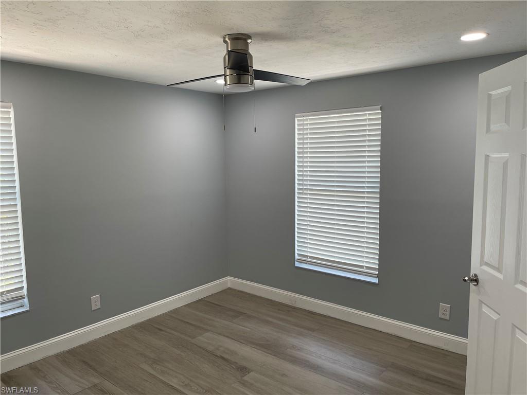 528 14th Street North Naples, FL 34102 - Photo 16 of 19 a view of an empty room with wooden floor and a window