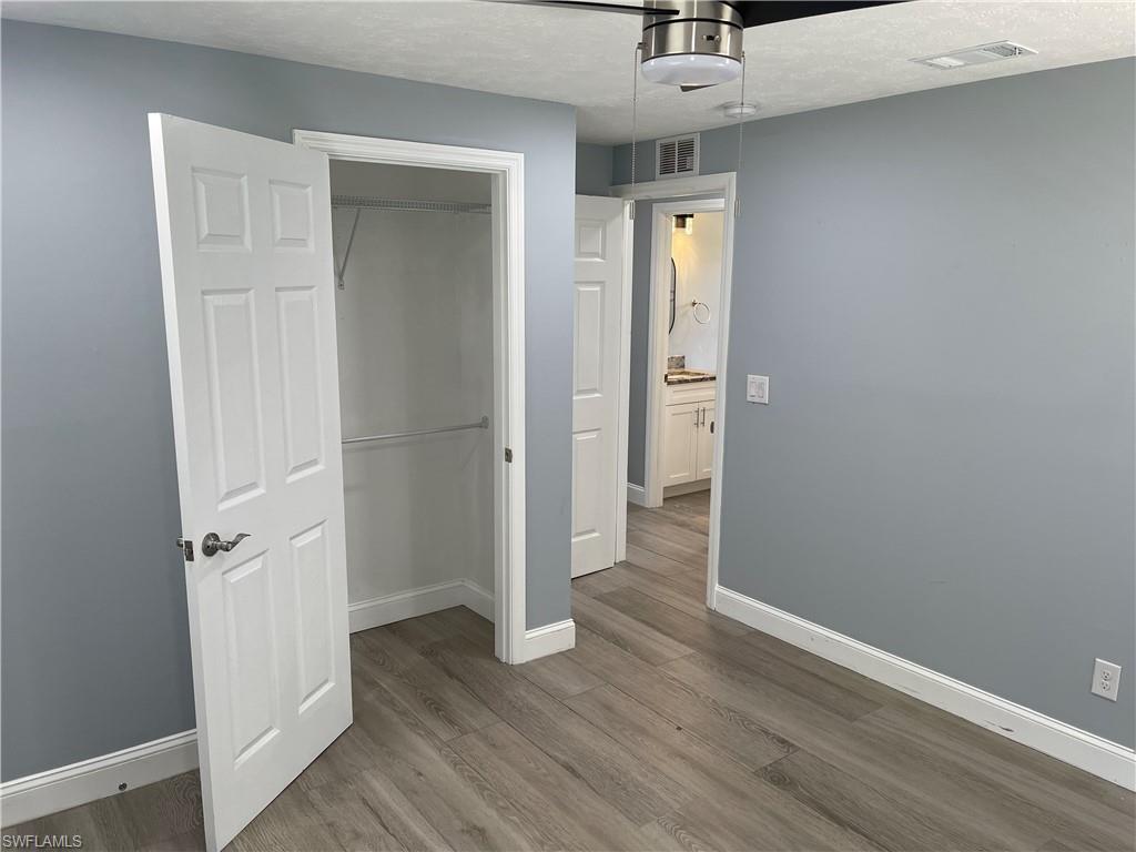 528 14th Street North Naples, FL 34102 - Photo 17 of 19 an empty room with a hardwood and wooden floor