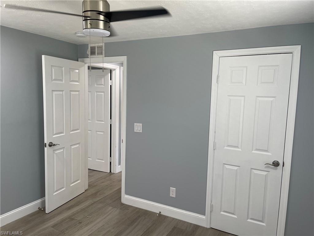 528 14th Street North Naples, FL 34102 - Photo 19 of 19 wooden floor in an empty room