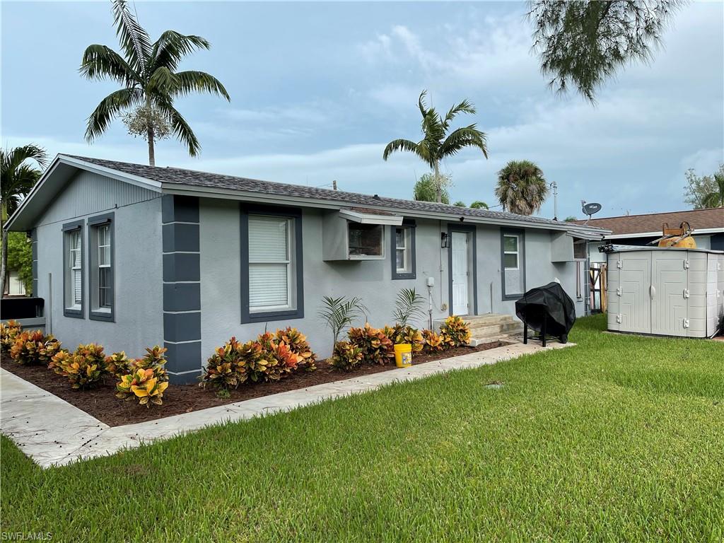 528 14th Street North Naples, FL 34102 - Photo 2 of 19 a front view of a house with garden