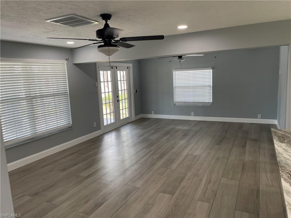 528 14th Street North Naples, FL 34102 - Photo 9 of 19 a view of an empty room with wooden floor and a window