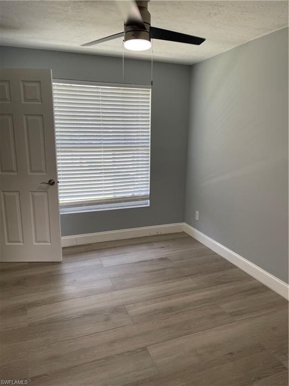 528 14th Street North Naples, FL 34102 - Photo 10 of 19 a view of an empty room with wooden floor and a window