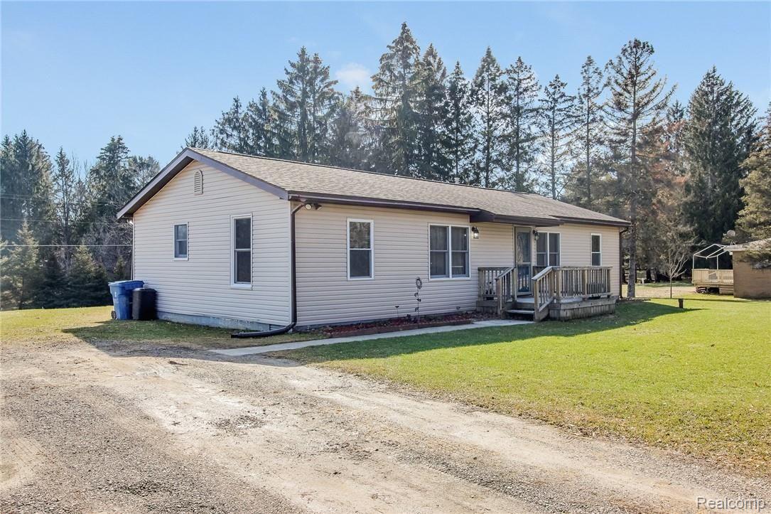 3138 West Rattalee Lake Road Holly, MI 48442 - Photo 2 of 25 Driveway side of home, plenty of space to add a garage.