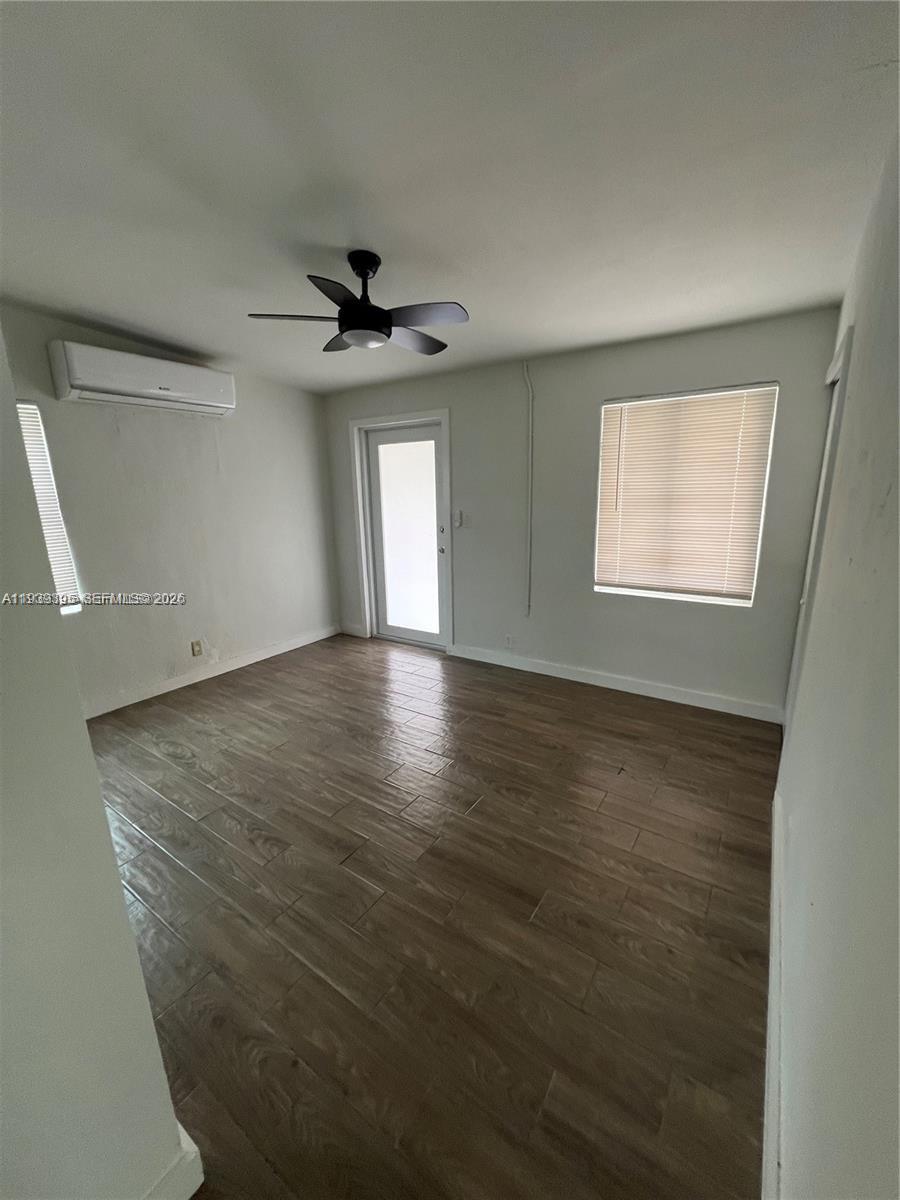 2240 Rutland Street Opa-Locka, FL 33054 - Photo 11 of 19 an empty room with windows and a ceiling fan