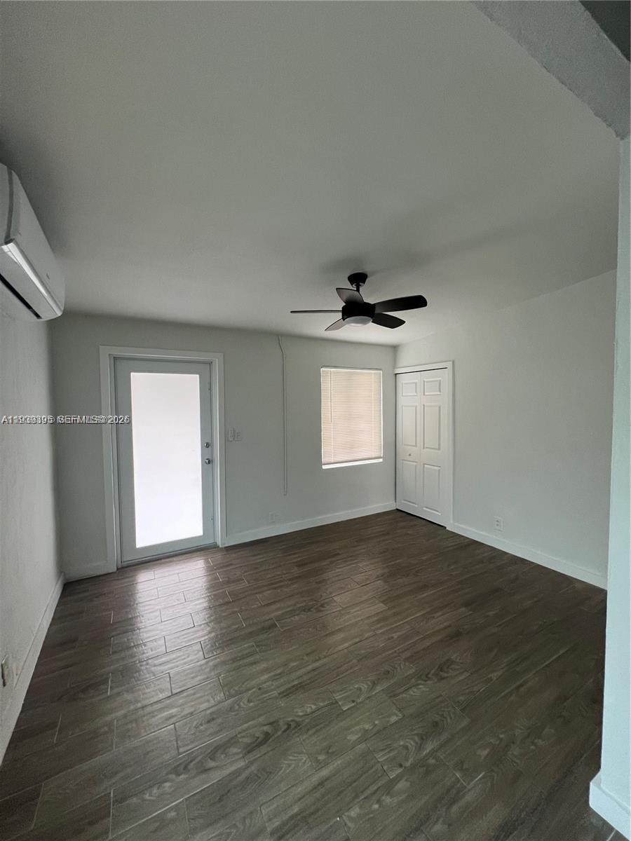 2240 Rutland Street Opa-Locka, FL 33054 - Photo 13 of 19 a view of an empty room with wooden floor and a window