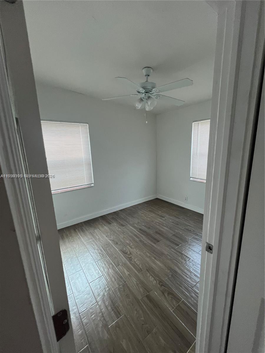 2240 Rutland Street Opa-Locka, FL 33054 - Photo 16 of 19 wooden floor in an empty room with a window
