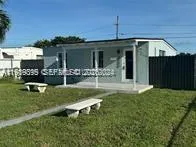 a front view of house with yard and outdoor seating