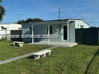 2240 Rutland Street Opa-Locka, FL 33054 - Photo 4 of 19 a front view of house with yard and outdoor seating