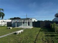 2240 Rutland Street Opa-Locka, FL 33054 - Photo 5 of 19 a view of a house with a yard and sitting area