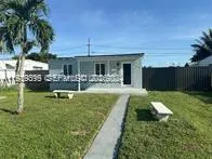 a view of a house with swimming pool and a yard