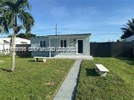 2240 Rutland Street Opa-Locka, FL 33054 - Photo 6 of 19 a view of a house with swimming pool and a yard
