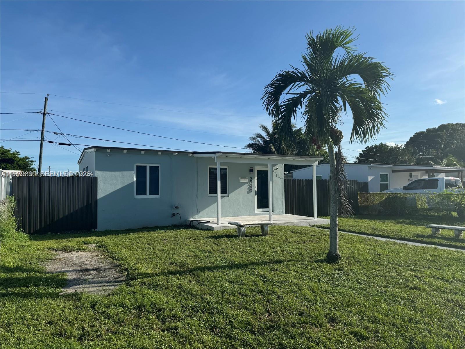 2240 Rutland Street Opa-Locka, FL 33054 - Photo 9 of 19 a front view of a house with garden