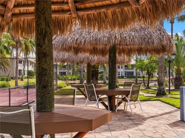 a view of a patio with a table and chairs