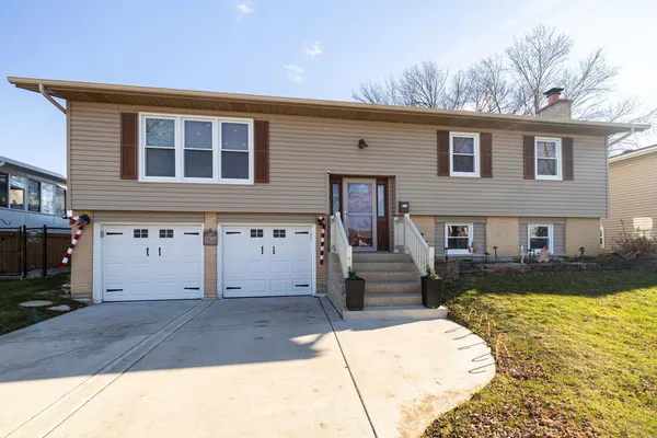 a front view of a house with a yard and garage