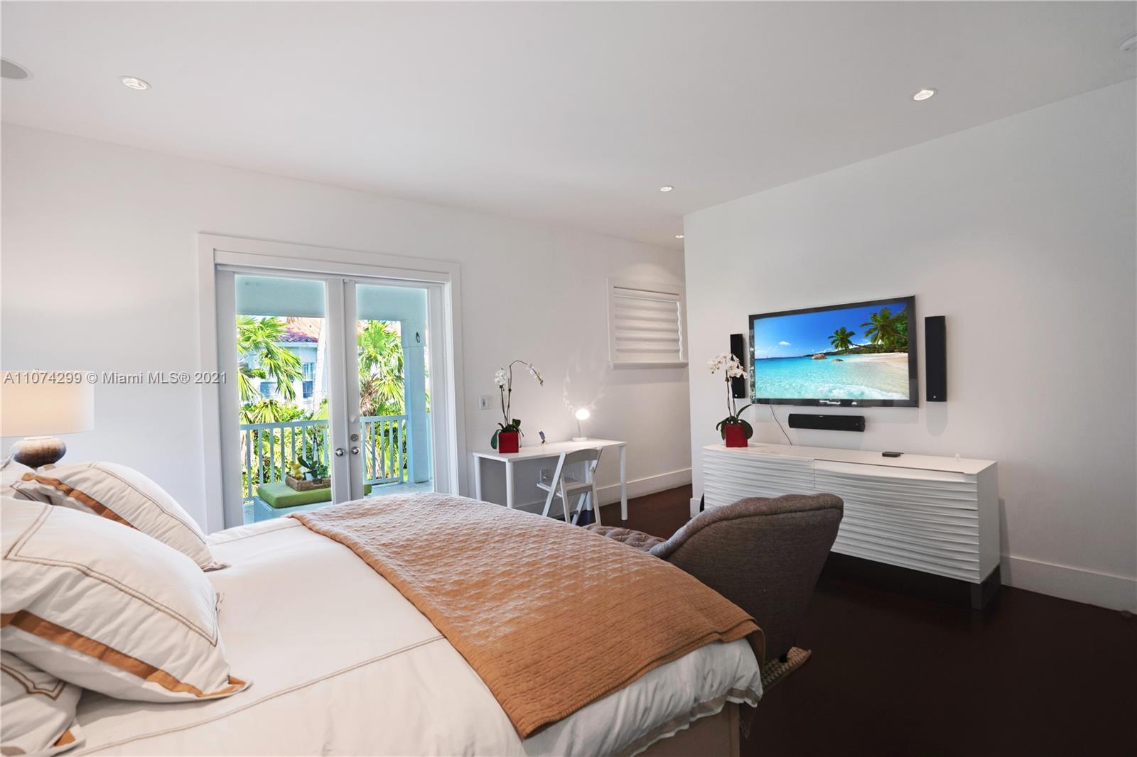 325 Hampton Lane Key Biscayne, FL 33149 - Photo 14 of 37 a bedroom with a bed and a flat screen tv