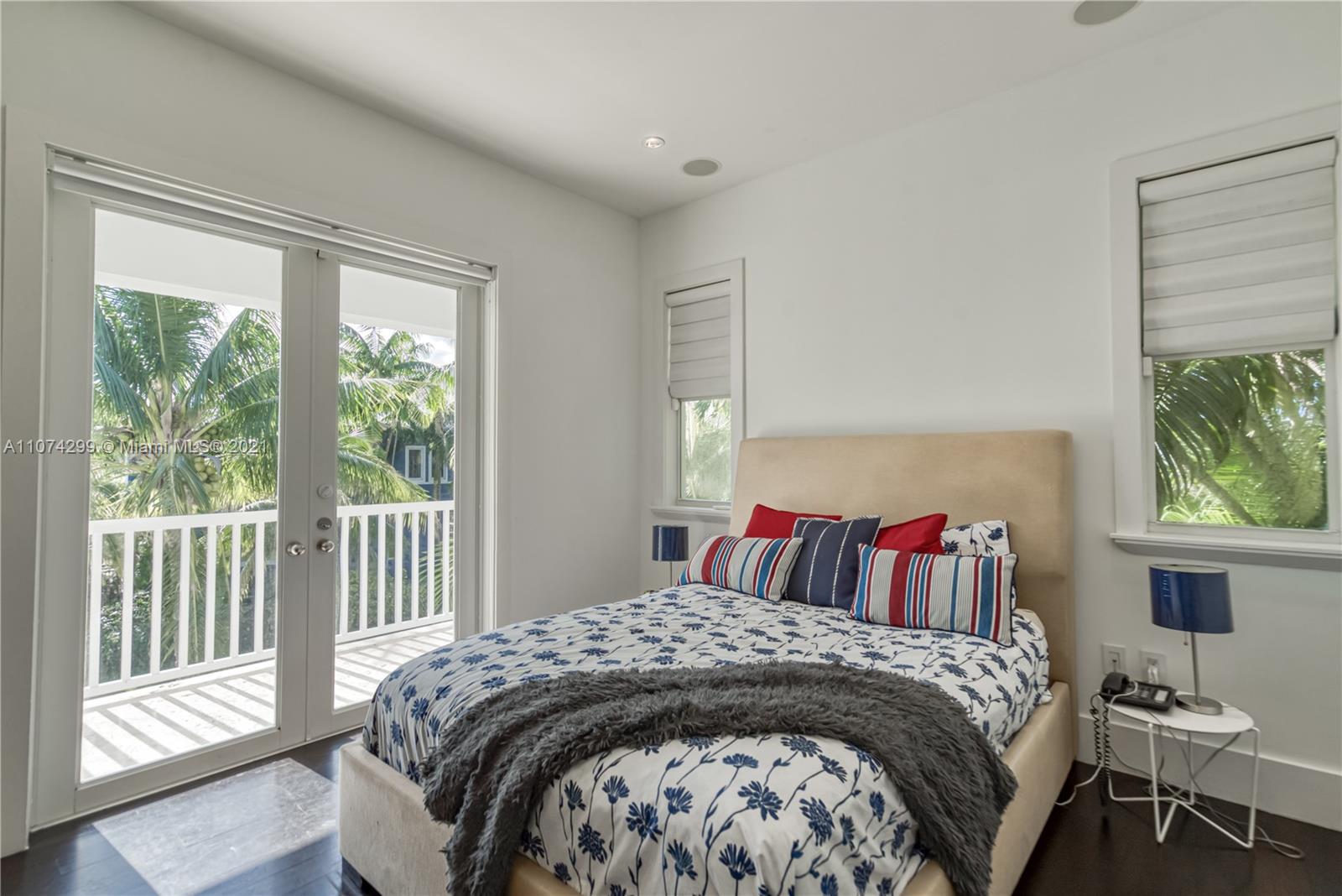 325 Hampton Lane Key Biscayne, FL 33149 - Photo 18 of 37 a bedroom with a bed and a window