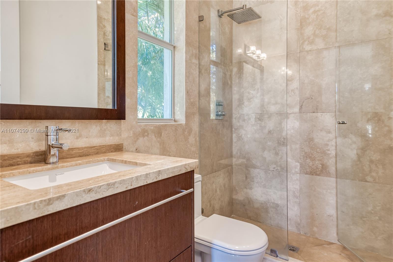 325 Hampton Lane Key Biscayne, FL 33149 - Photo 21 of 37 a bathroom with a sink a toilet and shower