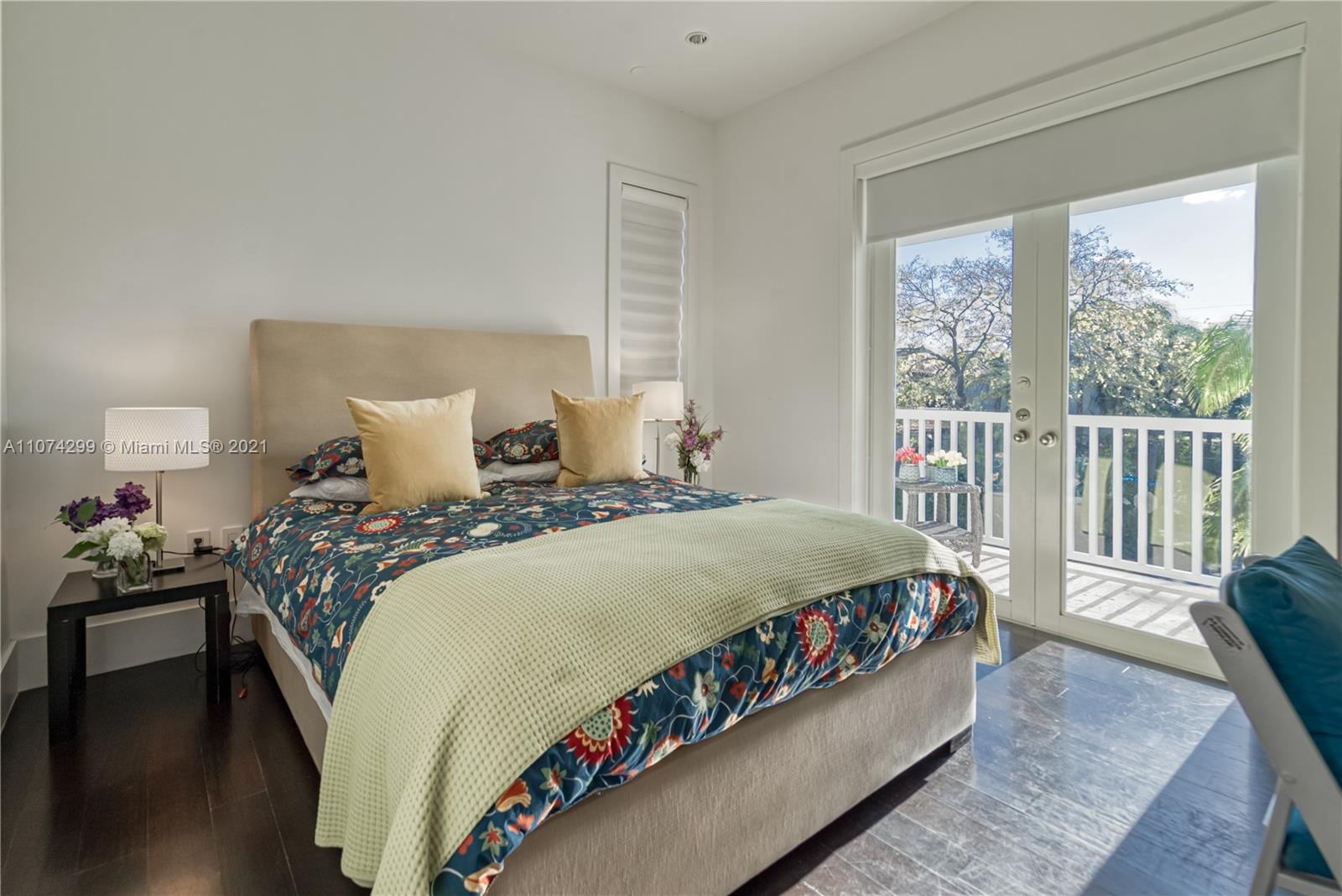 325 Hampton Lane Key Biscayne, FL 33149 - Photo 22 of 37 a bedroom with a bed and a large window