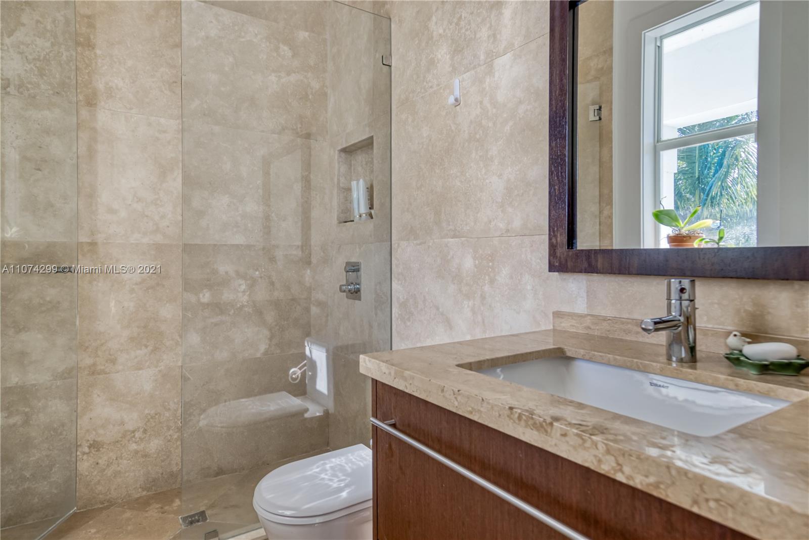 325 Hampton Lane Key Biscayne, FL 33149 - Photo 23 of 37 a bathroom with a granite countertop sink toilet and shower