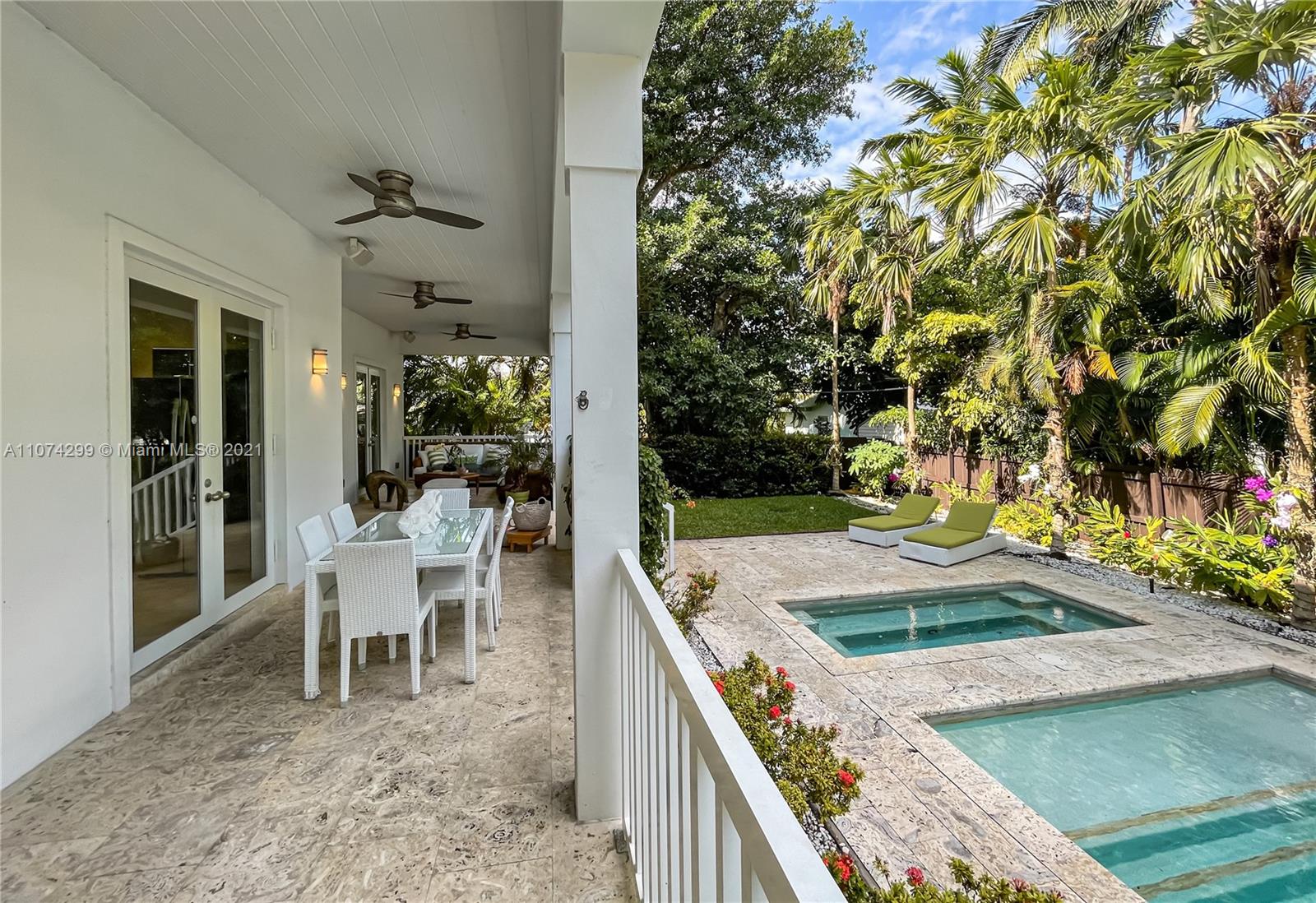 325 Hampton Lane Key Biscayne, FL 33149 - Photo 31 of 37 a view of a house with backyard porch and sitting area