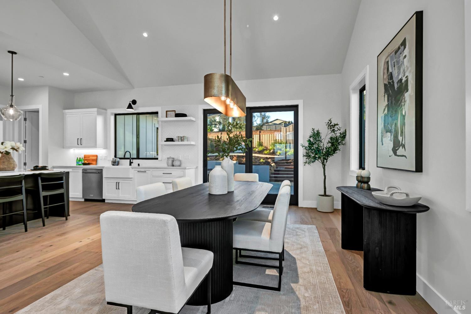 2011 Long Leaf Court Santa Rosa, CA 95403 - Photo 24 of 55 a dining room with kitchen island stainless steel appliances furniture a large window and a kitchen view