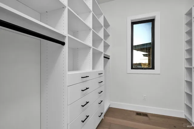 a bathroom with a granite countertop toilet sink and mirror