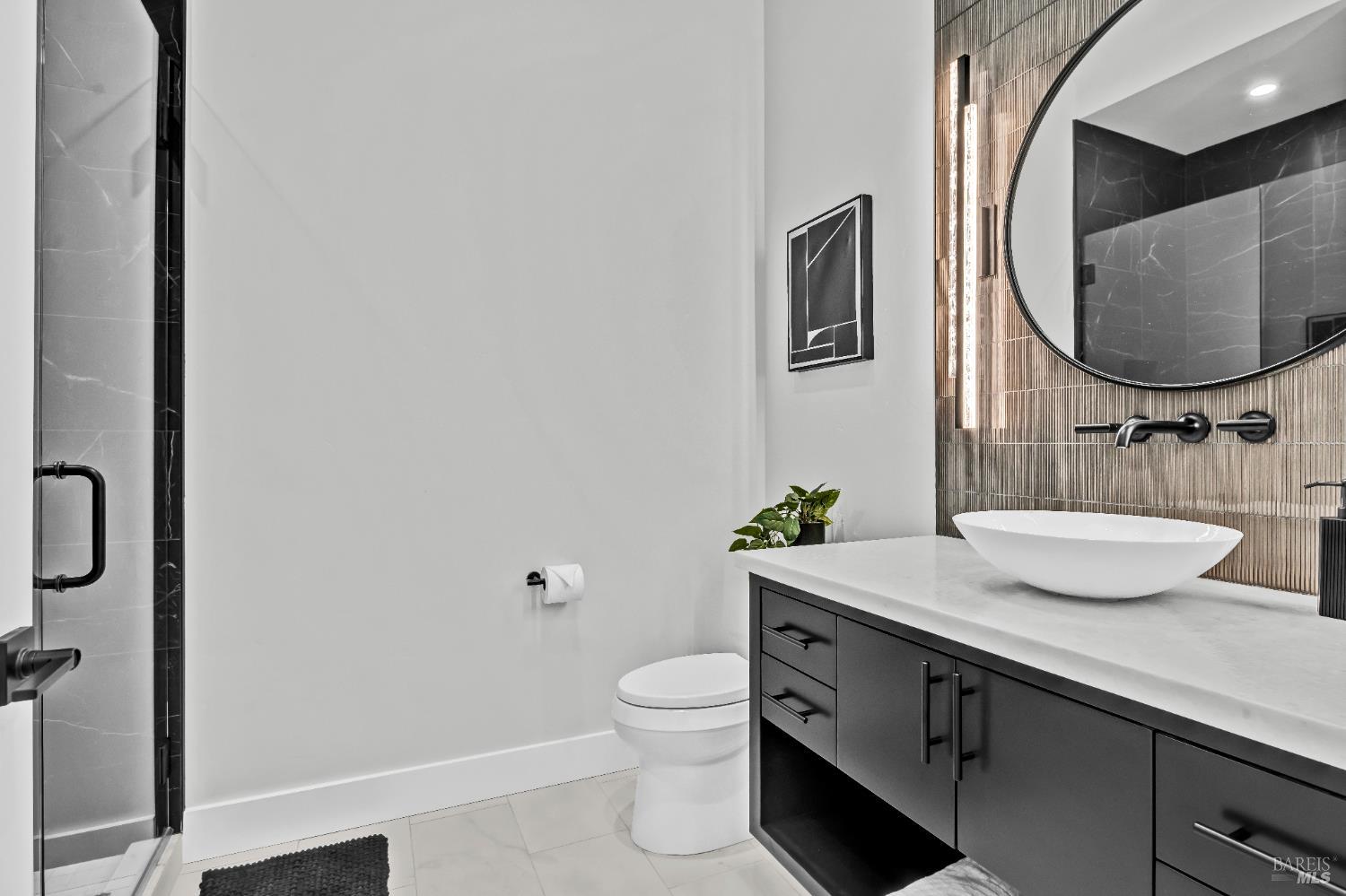 2011 Long Leaf Court Santa Rosa, CA 95403 - Photo 38 of 55 a bathroom with a granite countertop toilet sink and mirror