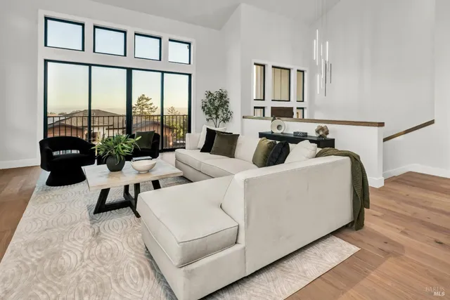 a living room with furniture fireplace and a large window