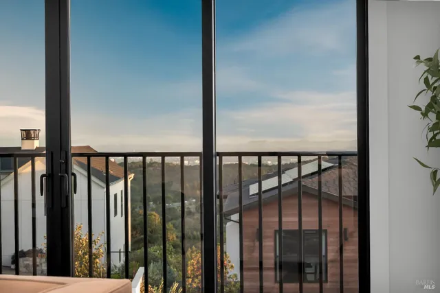 a living room with furniture and a dining table with kitchen view