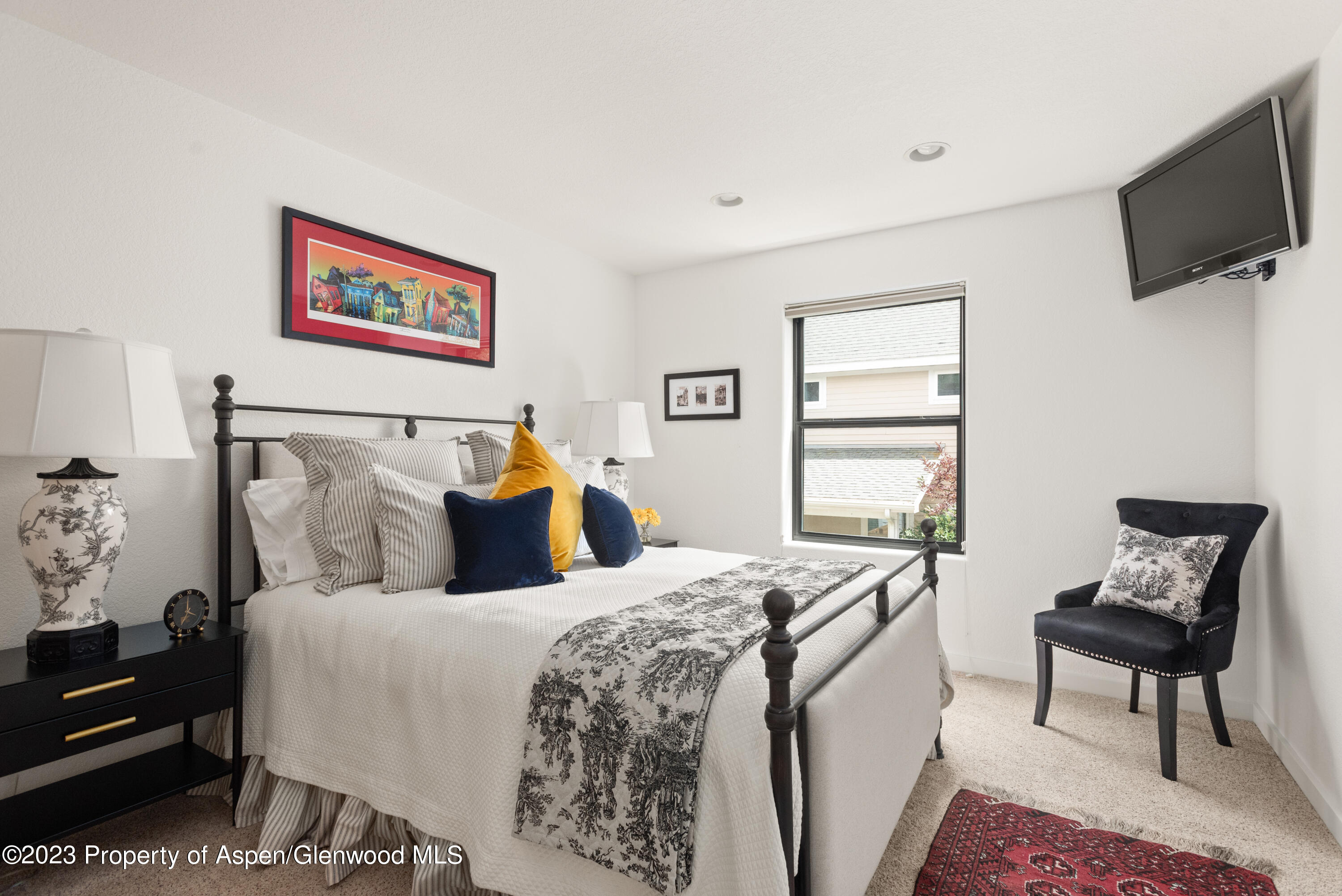 324 Summerset Lane Basalt, CO 81621 - Photo 28 of 40 a bedroom with a bed and a flat screen tv