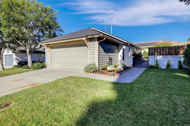 a view of a house with a yard and tree s