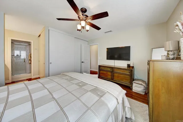 a bedroom with a bed and a flat screen tv