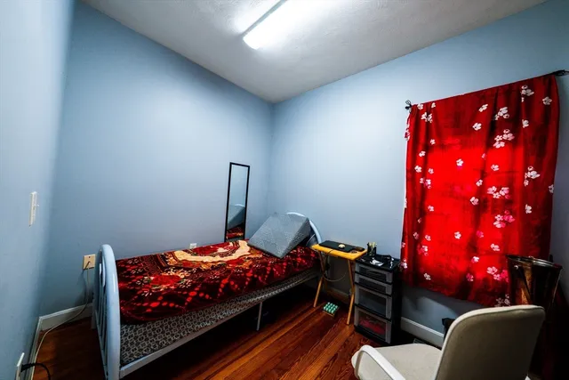 a bedroom with a bed and a lamp