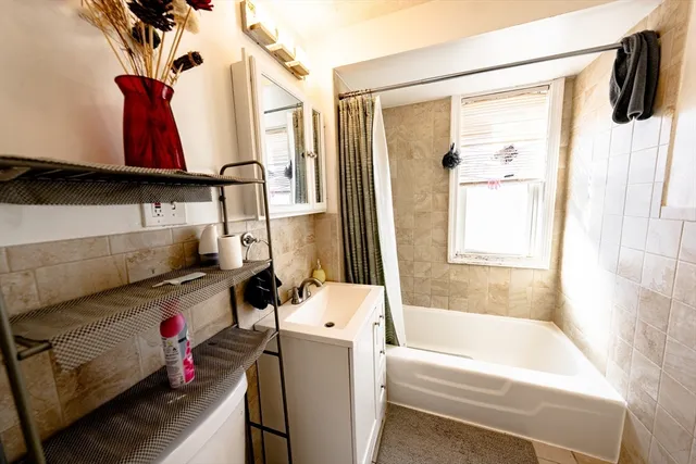 a bathroom with a bathtub and a shower