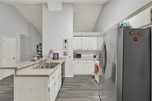 a kitchen with white cabinets and white stainless steel appliances