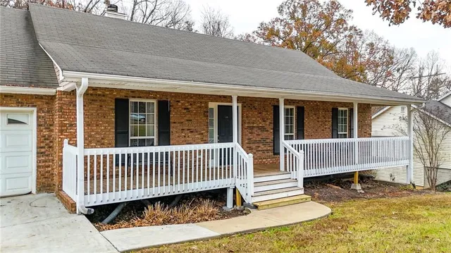 a view of a house with a wooden deck