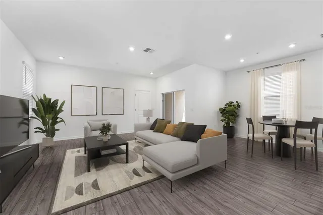 a living room with furniture or wooden floor and a potted plant