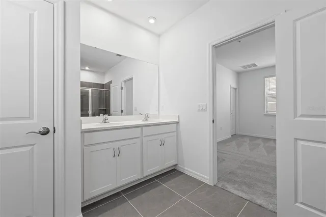 a spacious bathroom with a granite countertop sink mirror and a