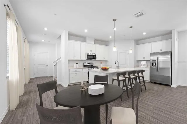 a view of kitchen with dining table and chairs
