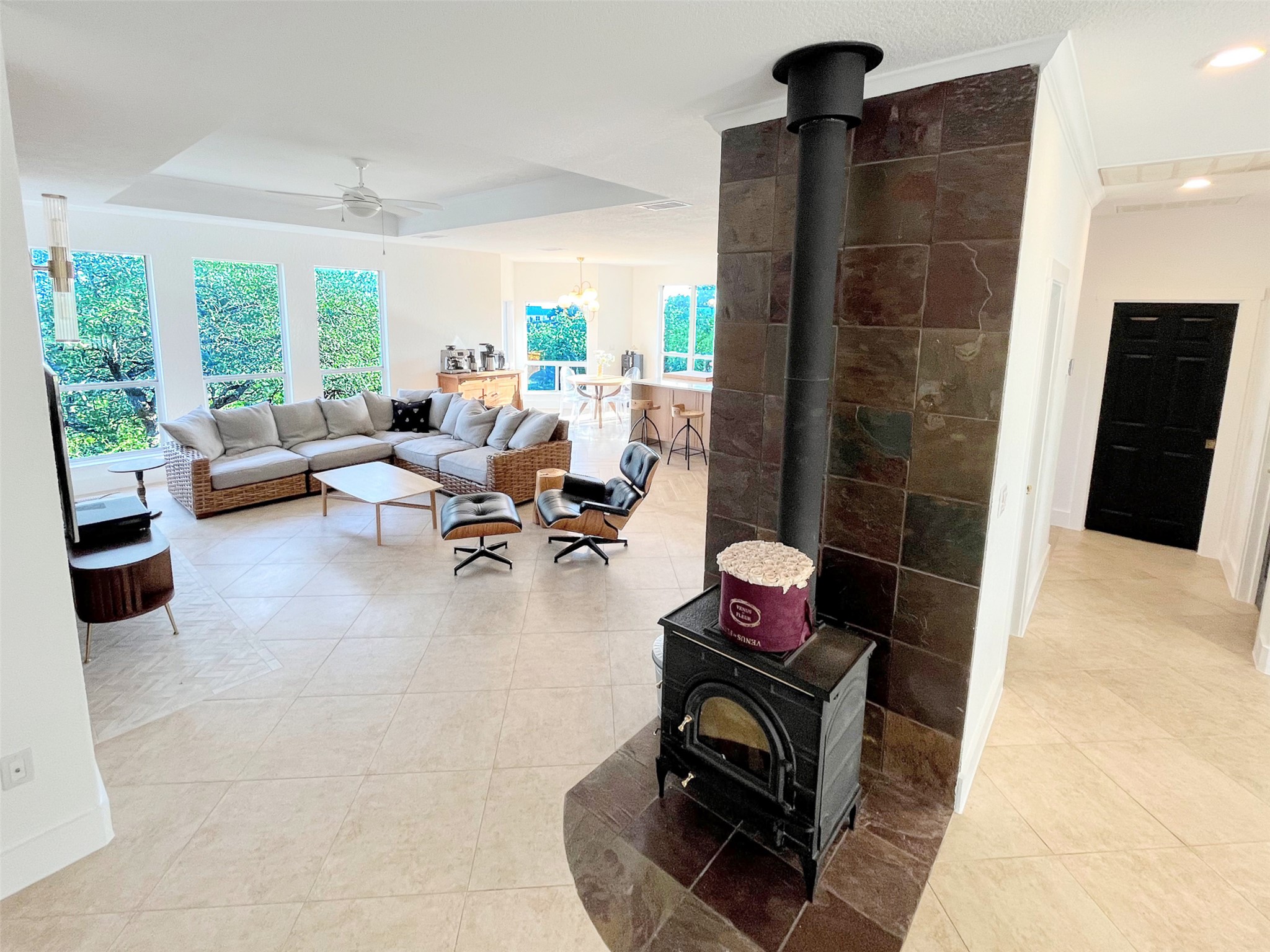 1015 Westland Ridge Road Dripping Springs, TX 78620 - Photo 10 of 32 An inviting open-concept living area with a cozy fireplace and abundant natural light from large windows.